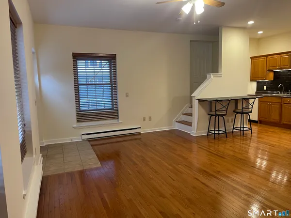 an empty room with wooden floor and workspace