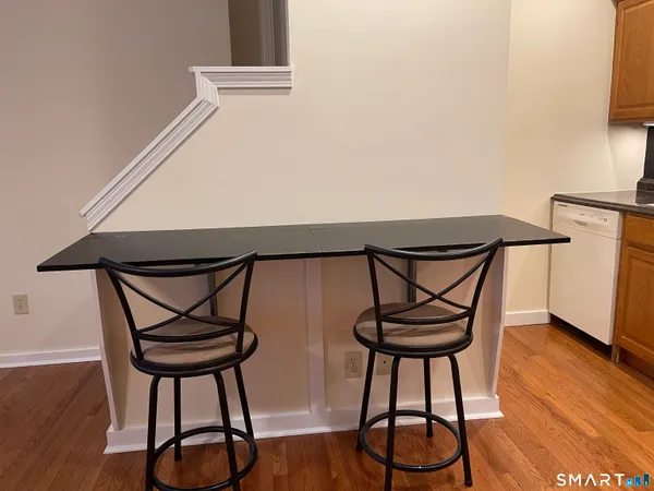 a picture of wooden floor with a table and a chair