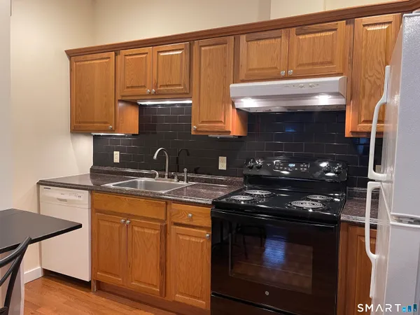 a kitchen with stainless steel appliances granite countertop a stove and a microwave