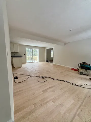 a view of a room with a sink and cabinets