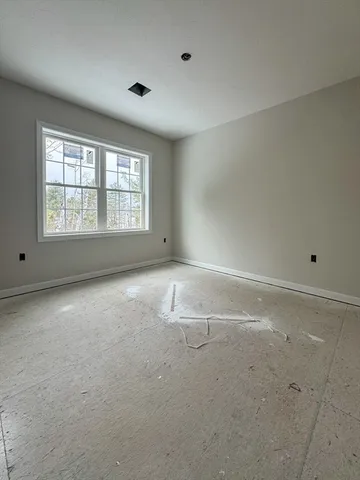 an empty room with a empty space and windows