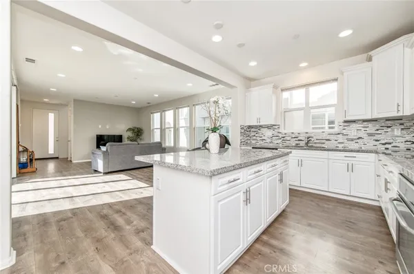 a kitchen with stainless steel appliances kitchen island granite countertop a sink and cabinets