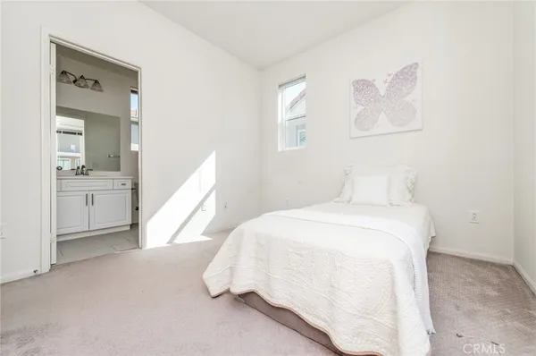 a bed room with a bed and a view of bedroom