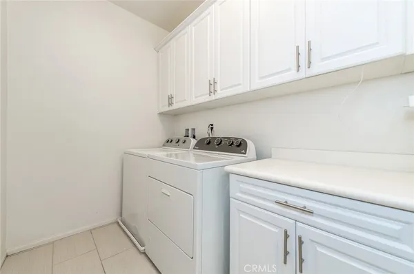 a bedroom with a large bed and next to a window