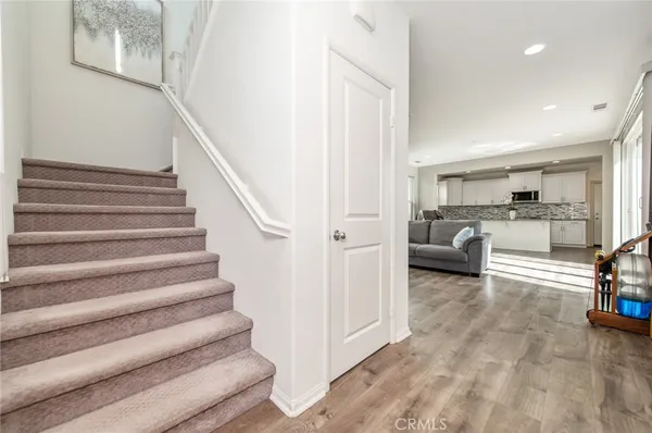 a view of a livingroom with furniture and staircase