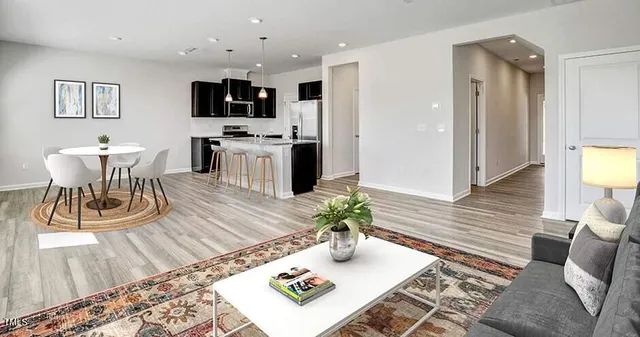 a living room with furniture and a wooden floor