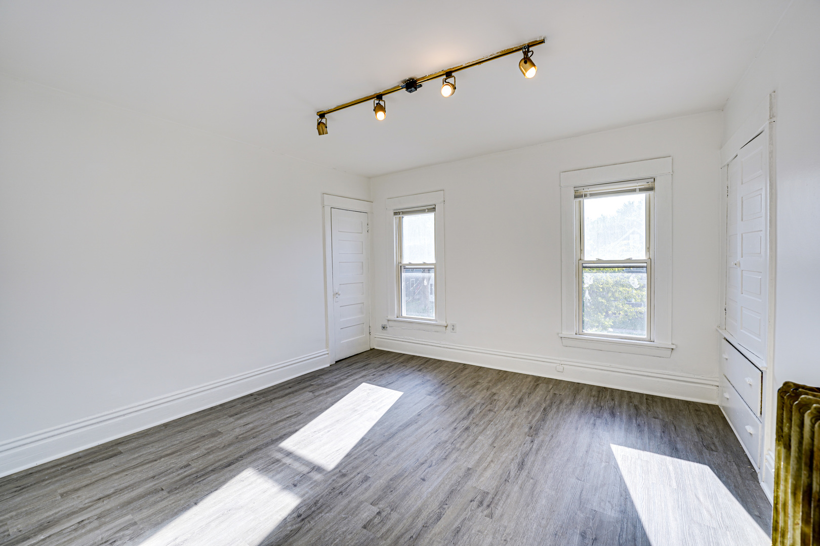 523 Grand Avenue, Unit 2 Aurora, IL 60506 - Photo 11 of 12 an empty room with wooden floor and windows