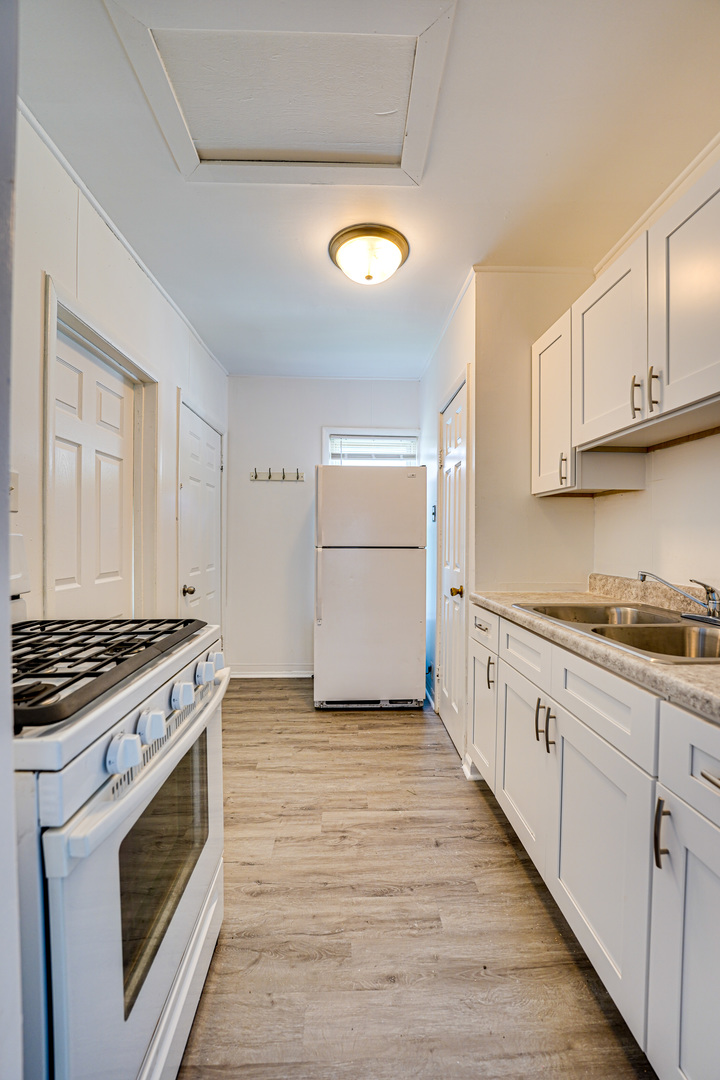 523 Grand Avenue, Unit 2 Aurora, IL 60506 - Photo 12 of 12 a kitchen with granite countertop a stove and a sink