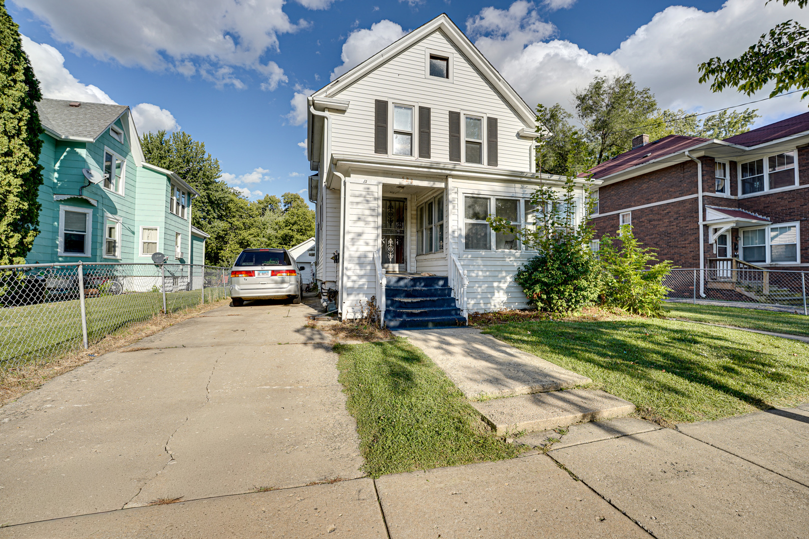 523 Grand Avenue, Unit 2 Aurora, IL 60506 - Photo 2 of 12 a front view of a house with a garden