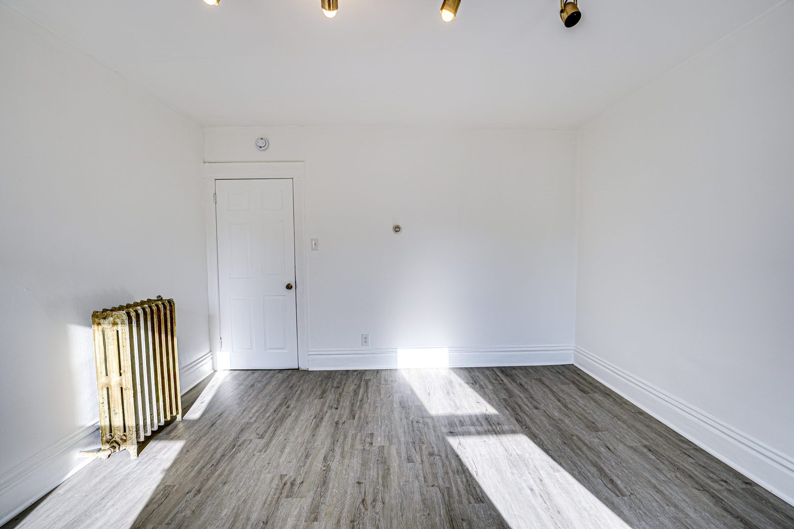 523 Grand Avenue, Unit 2 Aurora, IL 60506 - Photo 3 of 12 a view of empty room with wooden floor