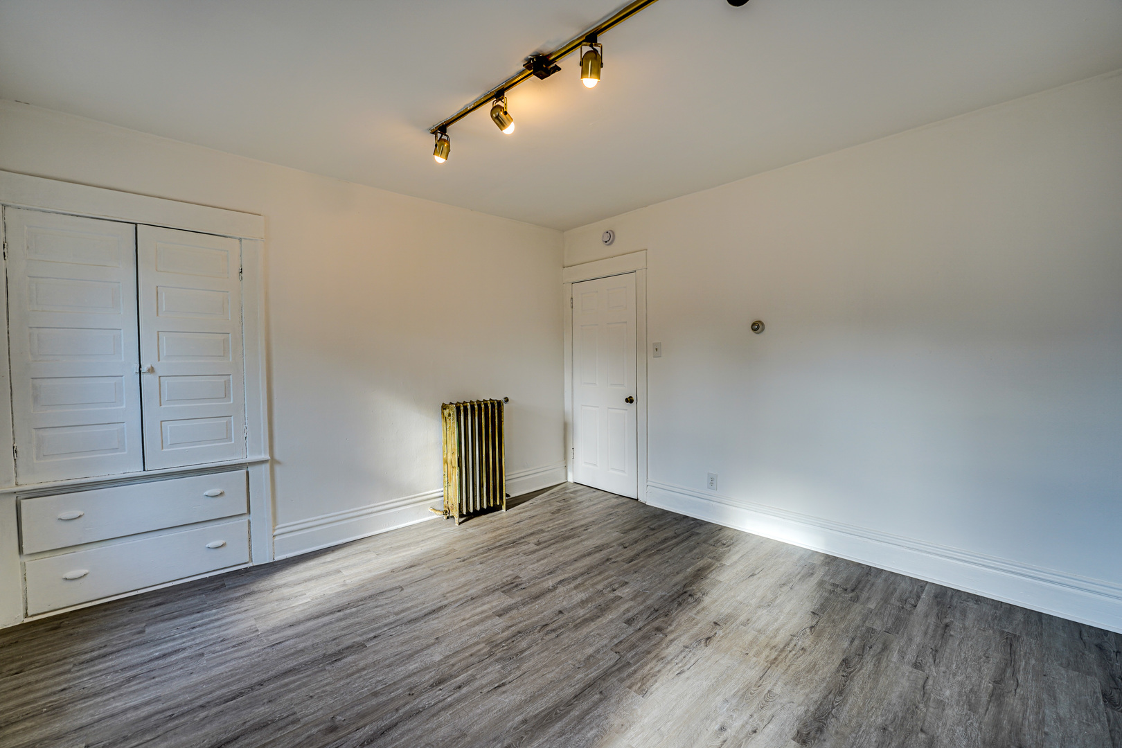 523 Grand Avenue, Unit 2 Aurora, IL 60506 - Photo 9 of 12 an empty room with wooden floor