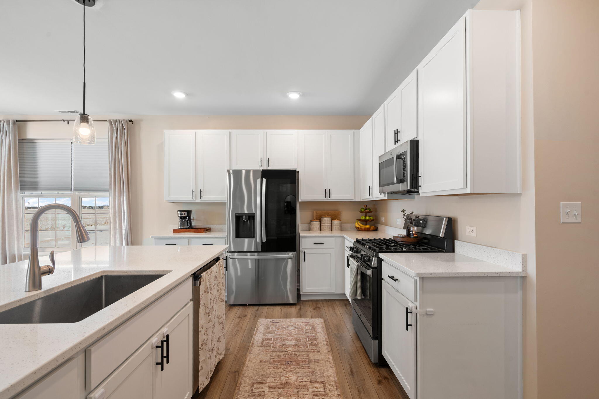 11664 Thomas Street Winfield, IN 46307 - Photo 12 of 30 a kitchen with white cabinets sink and stainless steel appliances