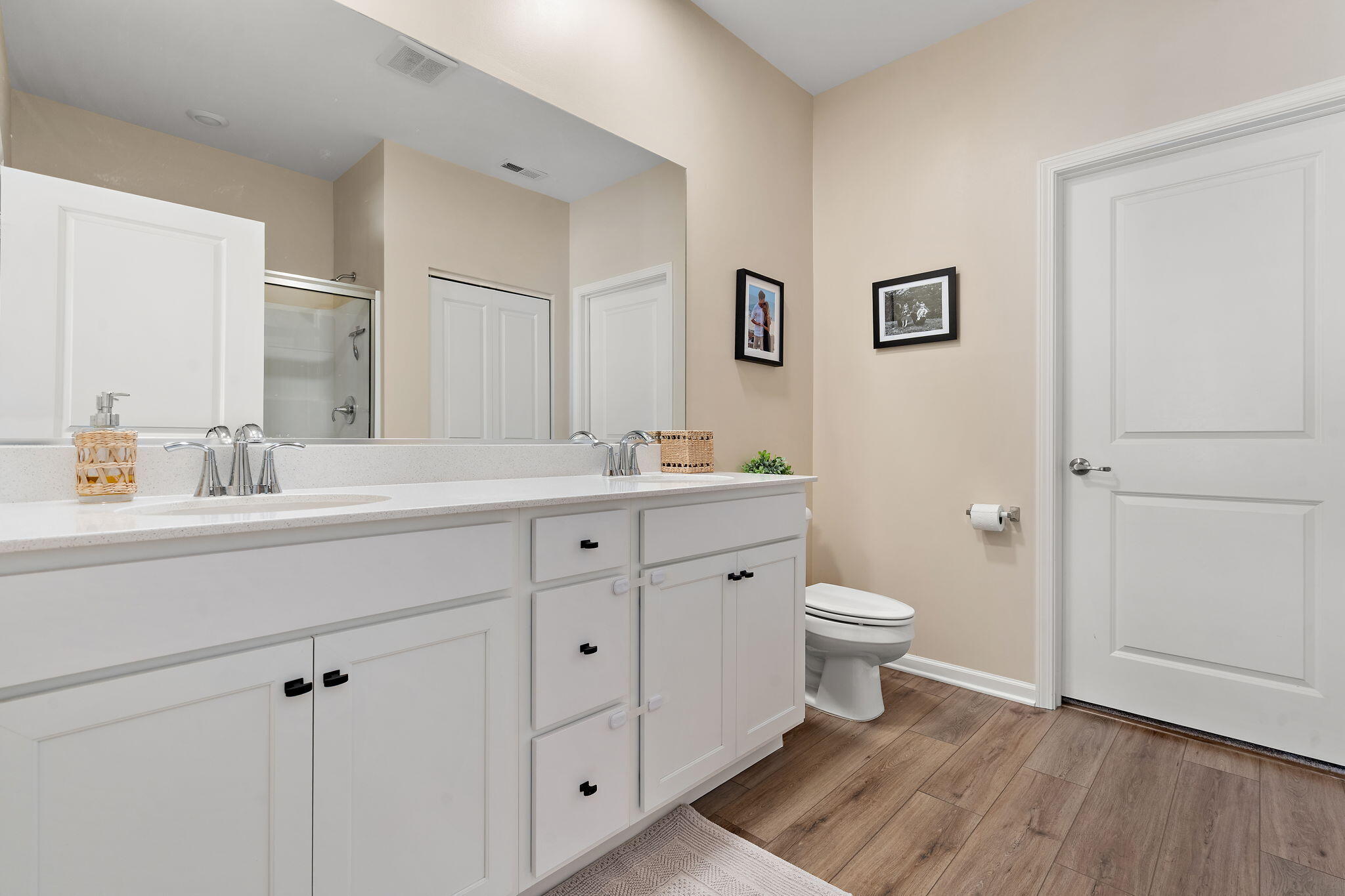 11664 Thomas Street Winfield, IN 46307 - Photo 18 of 30 a bathroom with a double vanity sink a mirror and toilet