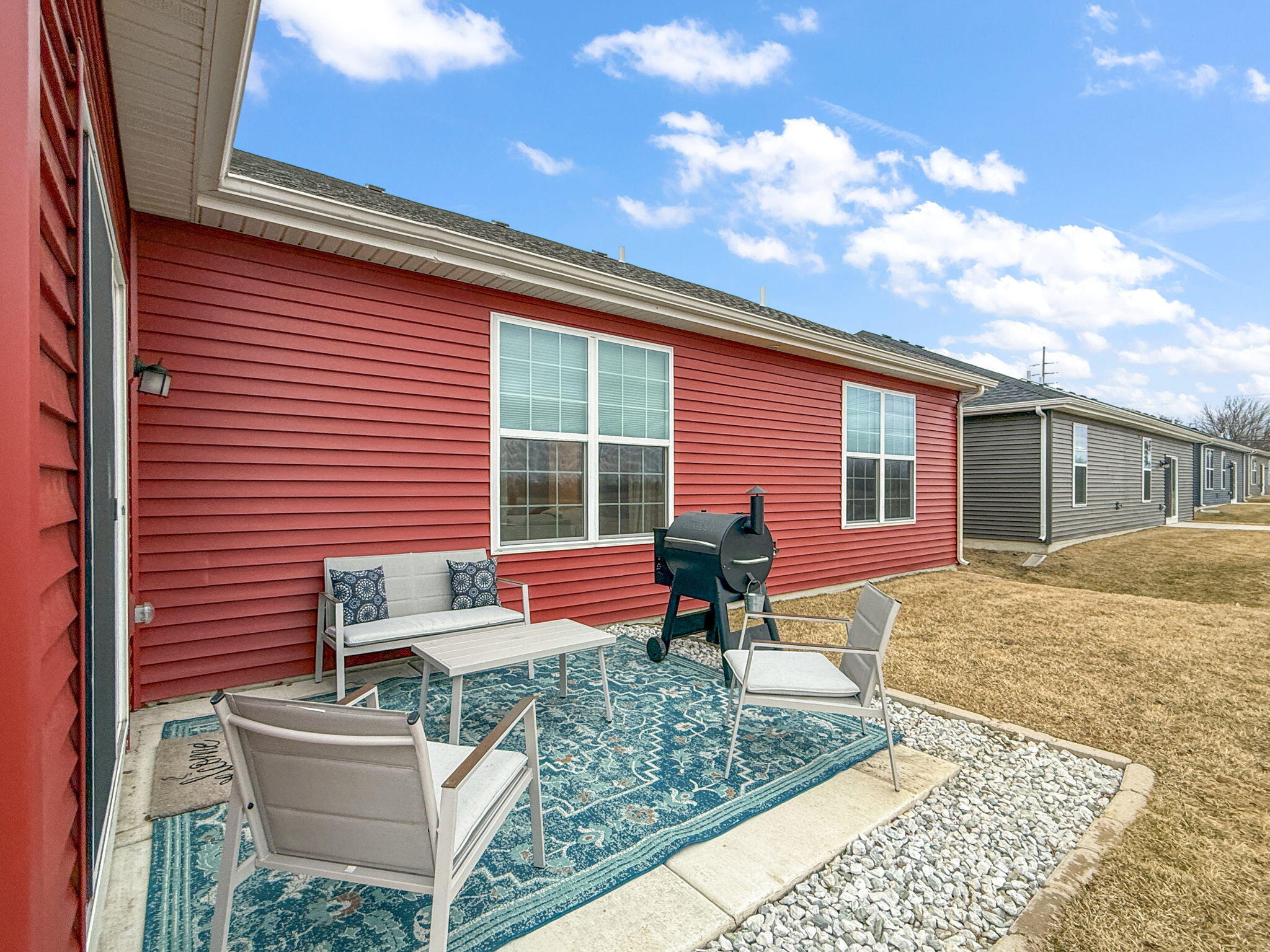 11664 Thomas Street Winfield, IN 46307 - Photo 25 of 30 a front view of a house with garden and seating area
