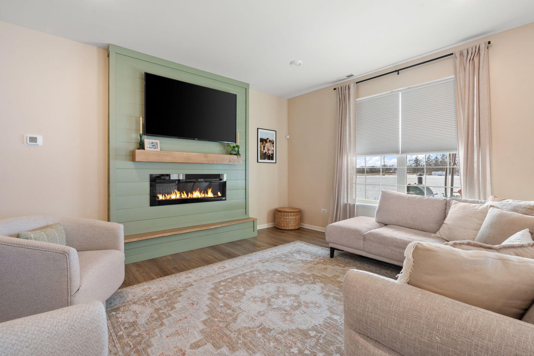 11664 Thomas Street Winfield, IN 46307 - Photo 8 of 30 a living room with furniture a flat screen tv and a fireplace