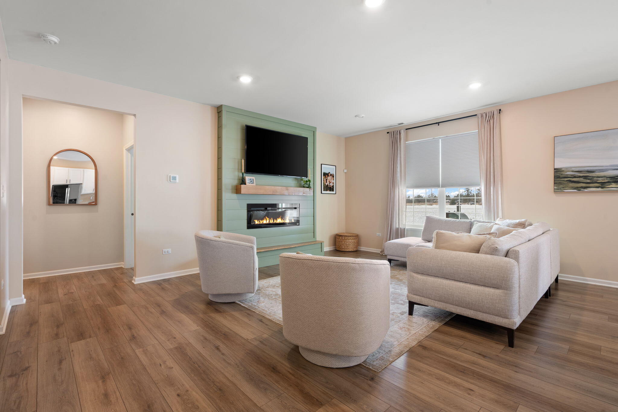 11664 Thomas Street Winfield, IN 46307 - Photo 9 of 30 a living room with furniture a flat screen tv and kitchen view