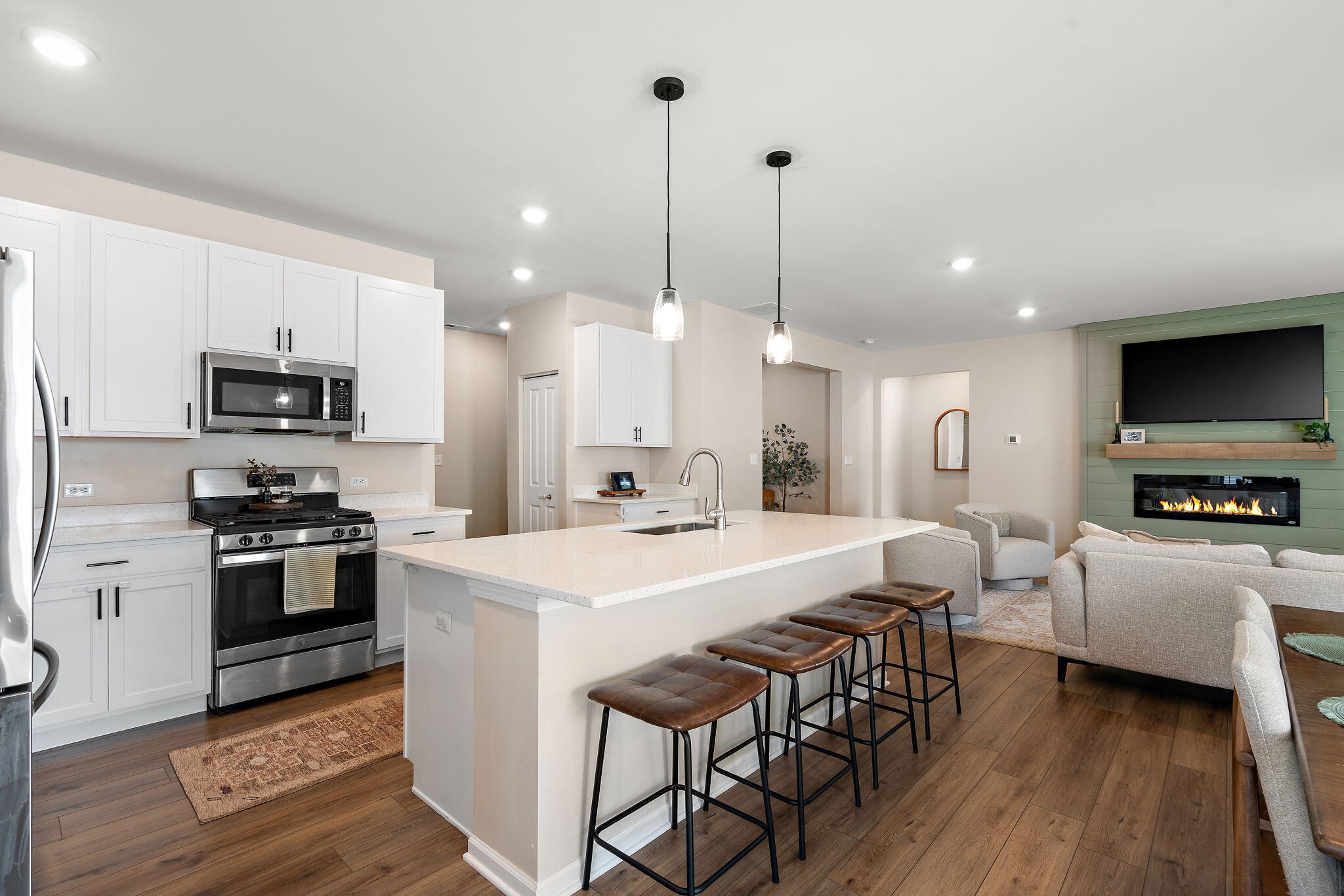 11664 Thomas Street Winfield, IN 46307 - Photo 10 of 30 a large kitchen with kitchen island granite countertop lots of white cabinets appliances and furniture