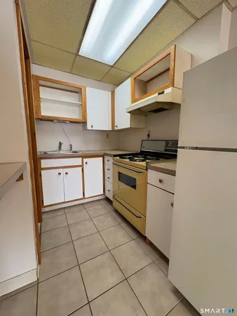 a kitchen with a stove a sink and a refrigerator