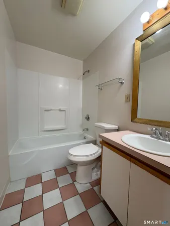 a bathroom with a sink a toilet and a mirror
