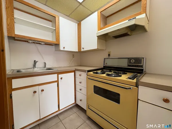 a kitchen with white cabinets and white appliances