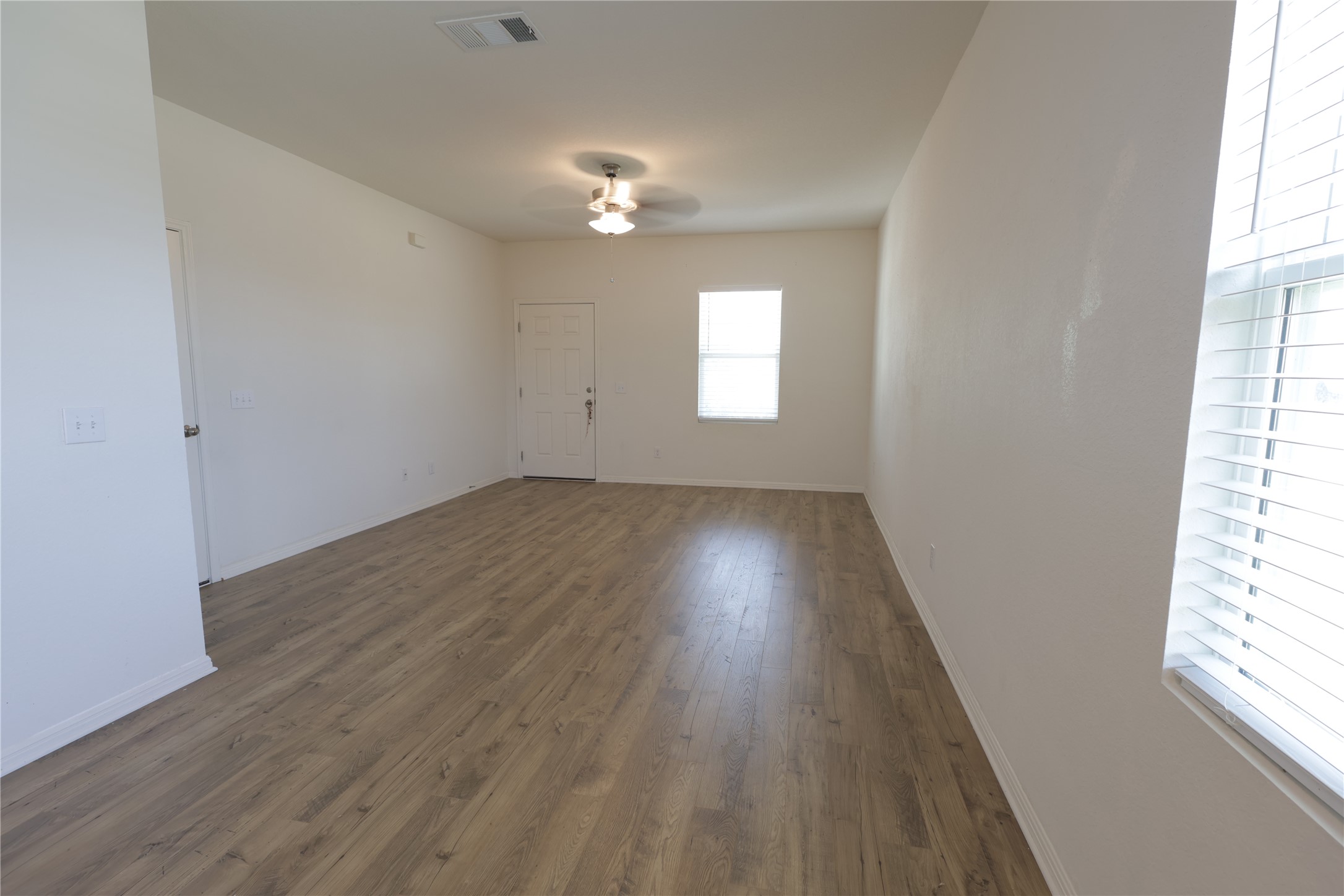 250 Seneca Loop Kyle, TX 78640 - Photo 4 of 22 A well-lit room offers durable wood flooring and a bright window.