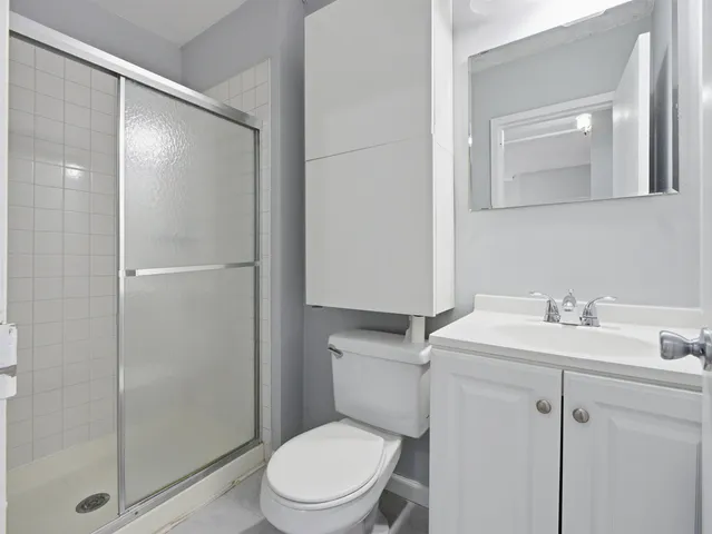 a white toilet sitting next to a bathroom sink