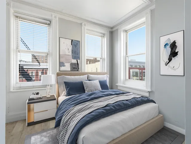 a bedroom with a large bed and a large window