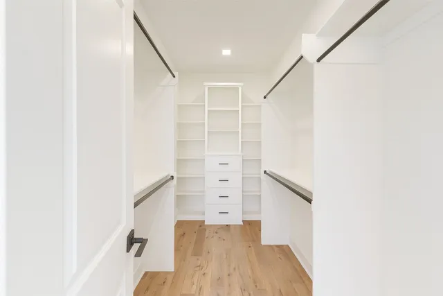 a bedroom with a bed and chair