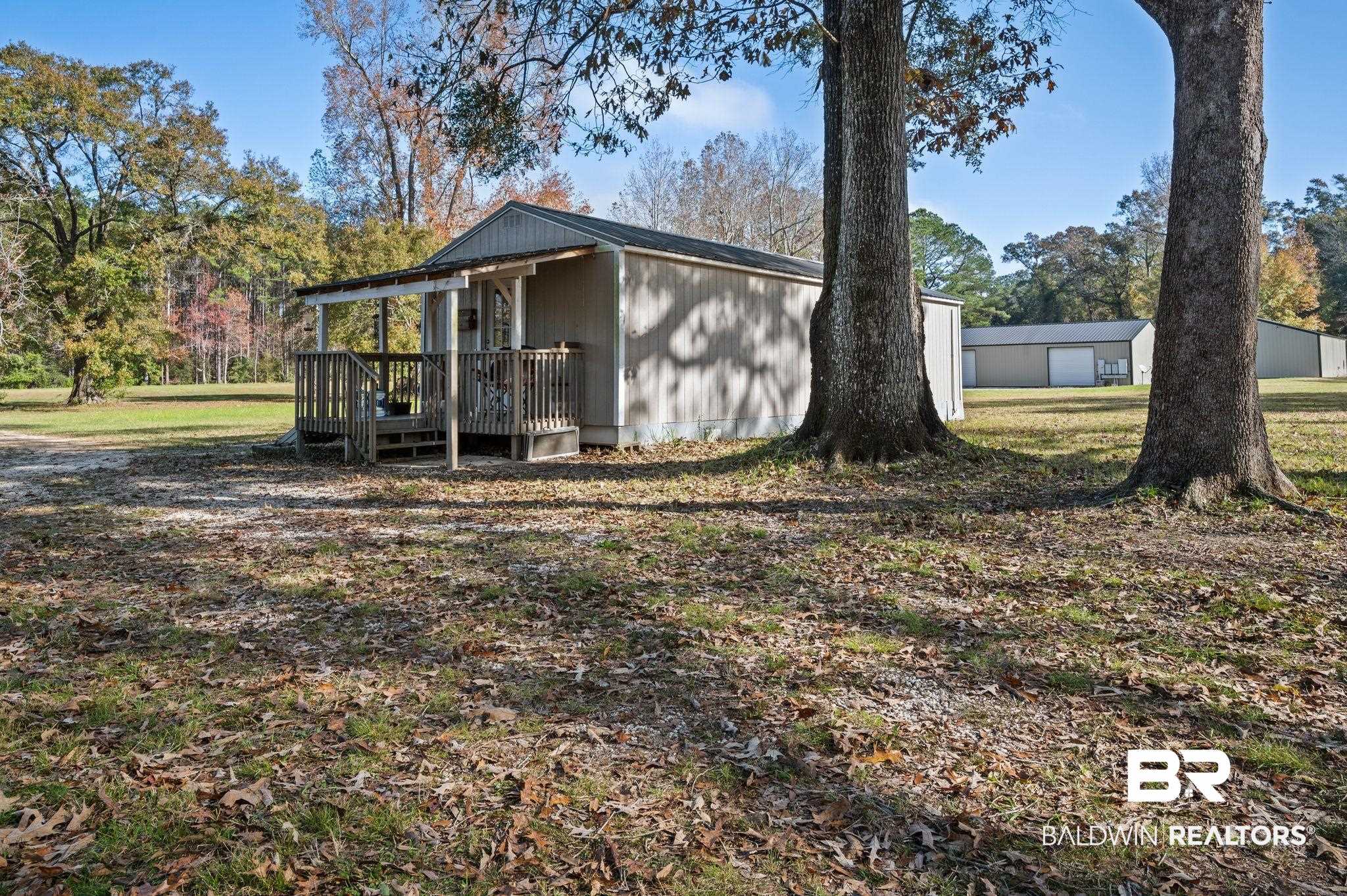 9382 D'Olive Street Bay Minette, AL 36507 - Photo 18 of 27 View of home's exterior featuring an outbuilding and a deck