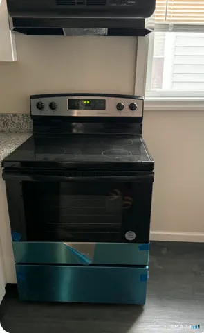 a stove top oven sitting inside of a kitchen