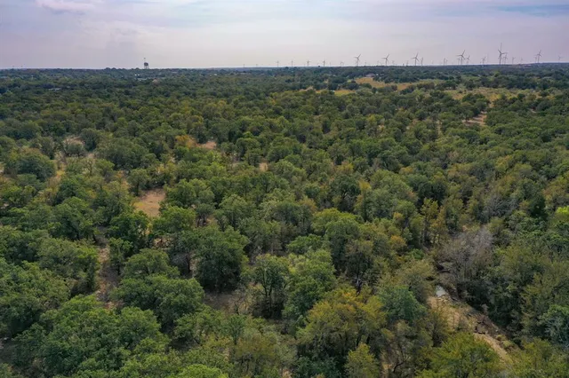 an aerial view of a houses with a yard