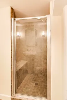 a bathroom with a glass shower door