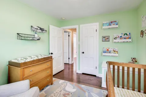 a room with furniture and baby crib