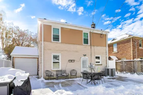 a front view of a house with outdoor seating