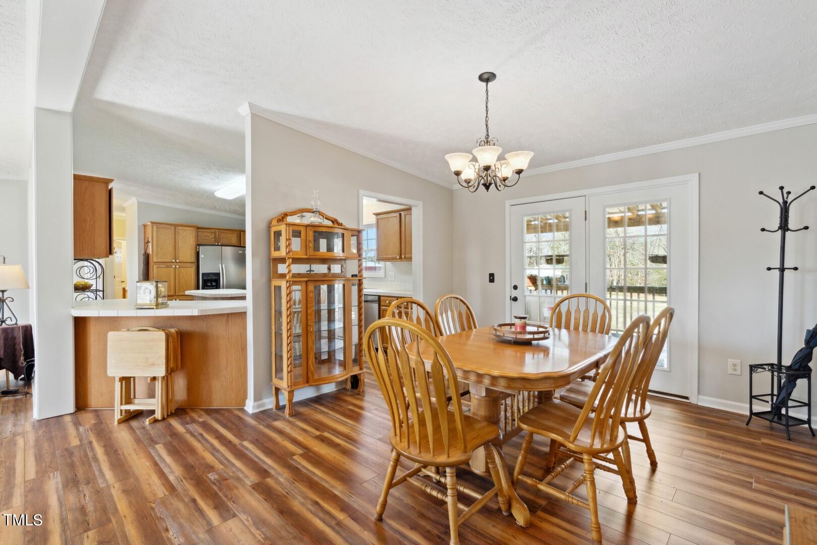 109 Double D Farm Road Angier, NC 27501 - Photo 8 of 42 a dining room with furniture a chandelier and wooden floor