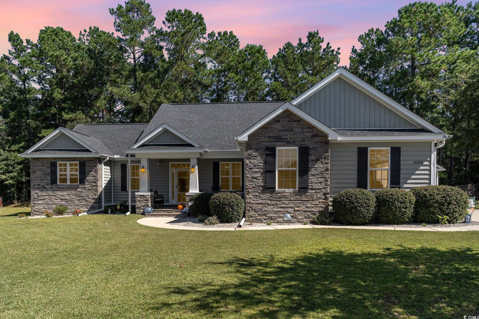 Craftsman-style home featuring a lawn