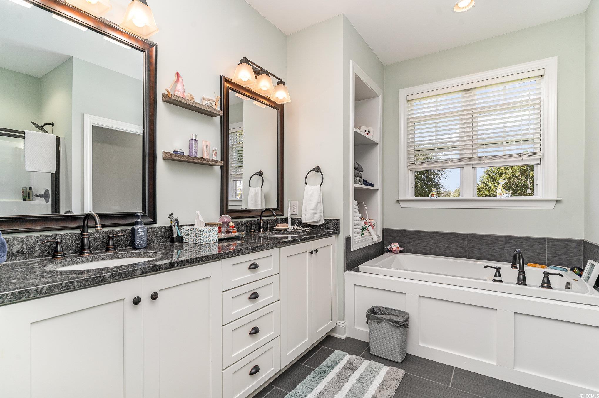 4204 Ridgewood Drive Conway, SC 29526 - Photo 19 of 38 Bathroom with a tub, built in shelves, and vanity