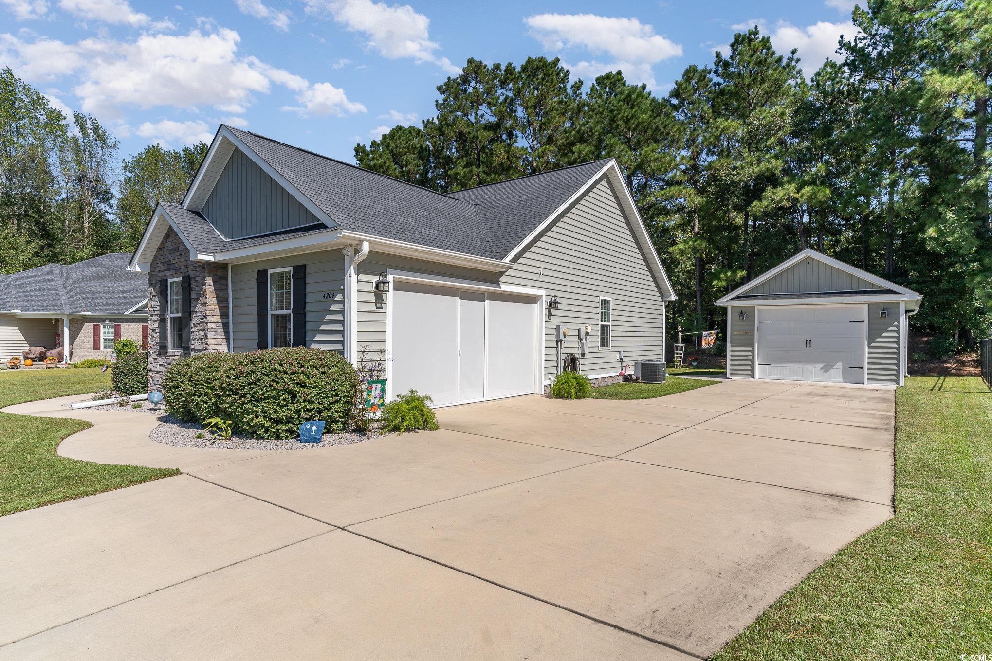 View of property exterior with an outdoor structur