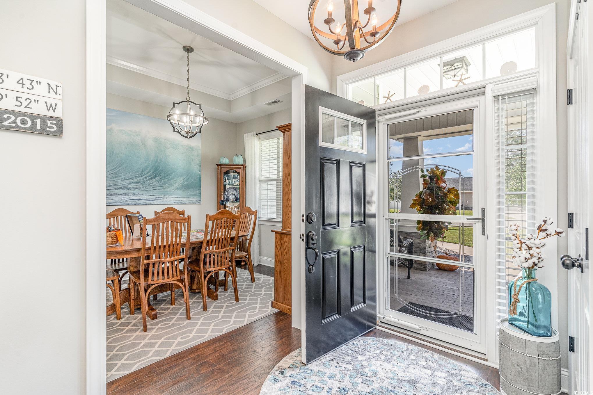 Entryway featuring ornamental molding, an inviting