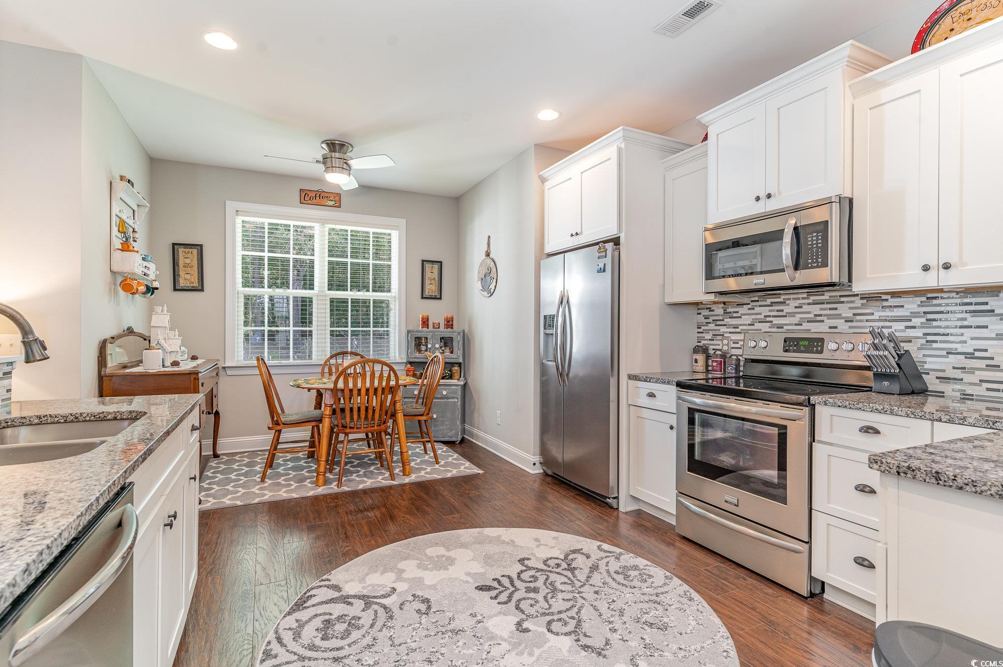 Kitchen featuring ceiling fan, stainless steel app