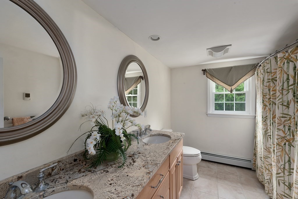 6 Trask Road Boxford, MA 01921 - Photo 21 of 36 a room with a mirror and a table