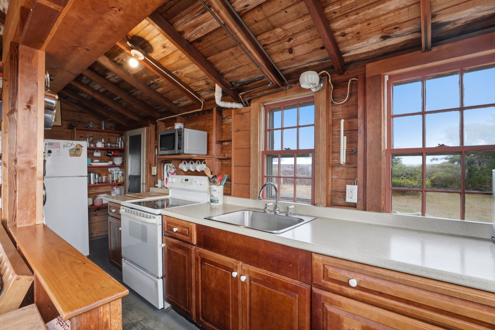 44 Madequecham Valley Road Nantucket, MA 02554 - Photo 5 of 19 a kitchen with a sink and large windows