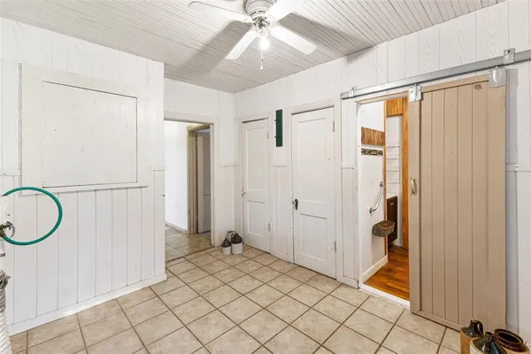 an empty room with windows and closet