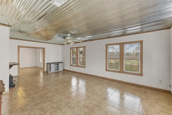 a view of an empty room with a fireplace and a window