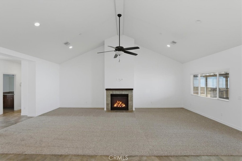 14202 Meadowlands Drive Riverside, CA 92503 - Photo 13 of 60 an empty room with a fireplace and fan