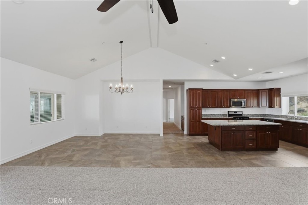 14202 Meadowlands Drive Riverside, CA 92503 - Photo 15 of 60 a large kitchen with stainless steel appliances granite countertop a stove and a refrigerator