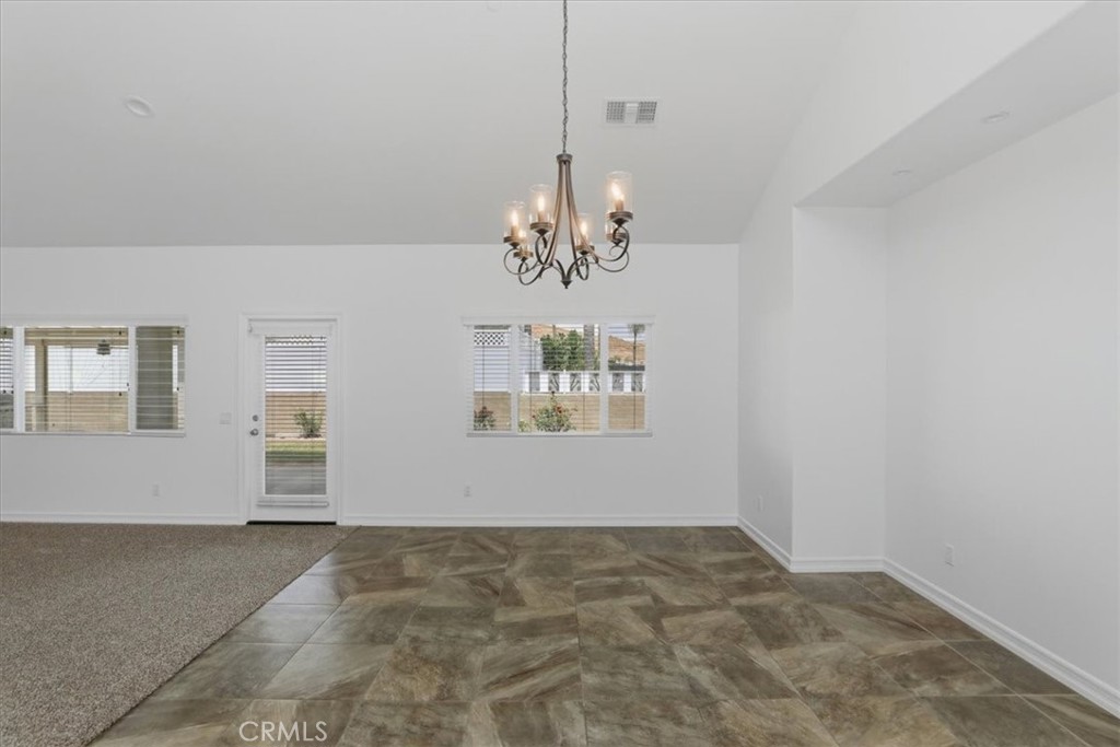 14202 Meadowlands Drive Riverside, CA 92503 - Photo 22 of 60 a view of a chandelier in an empty room