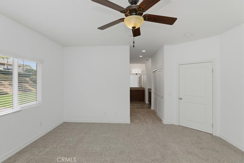 14202 Meadowlands Drive Riverside, CA 92503 - Photo 30 of 60 en empty room with ceiling fan and window