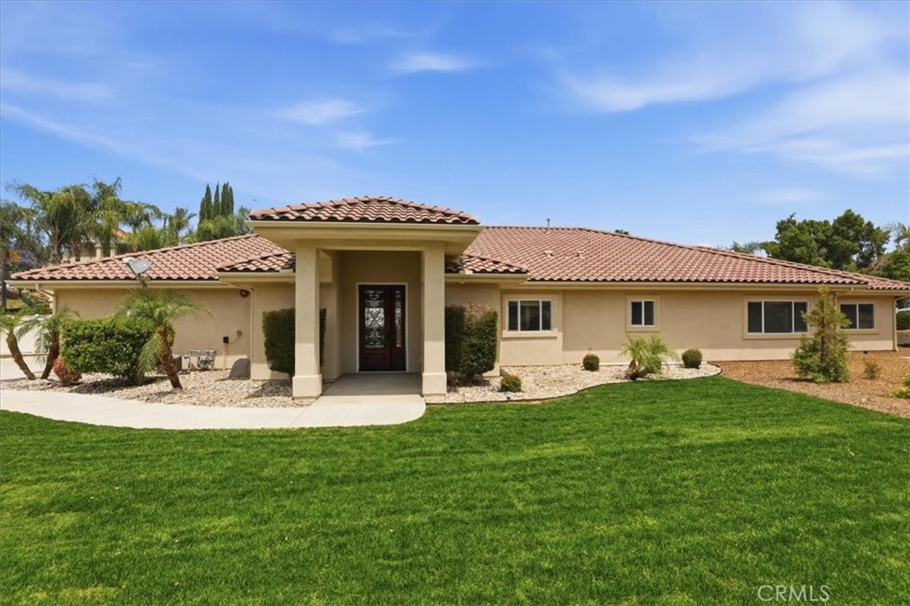 14202 Meadowlands Drive Riverside, CA 92503 - Photo 3 of 60 a front view of a house with garden and sitting area
