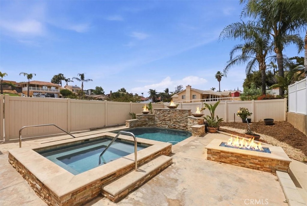 14202 Meadowlands Drive Riverside, CA 92503 - Photo 44 of 60 a view of a swimming pool with a lounge chairs